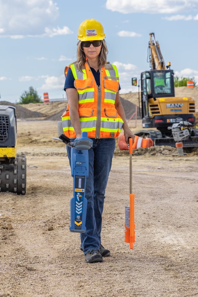 Female land surveyor with RD8200SG with paint marker stick